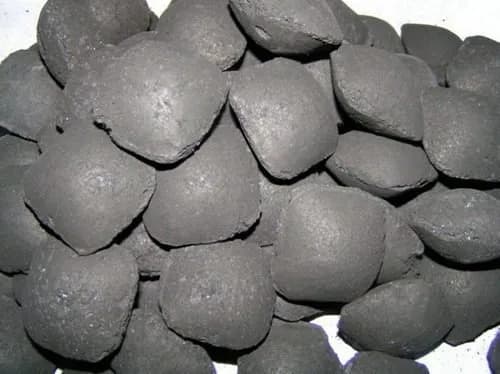 Pile of pillow-shaped coconut shell charcoal briquettes